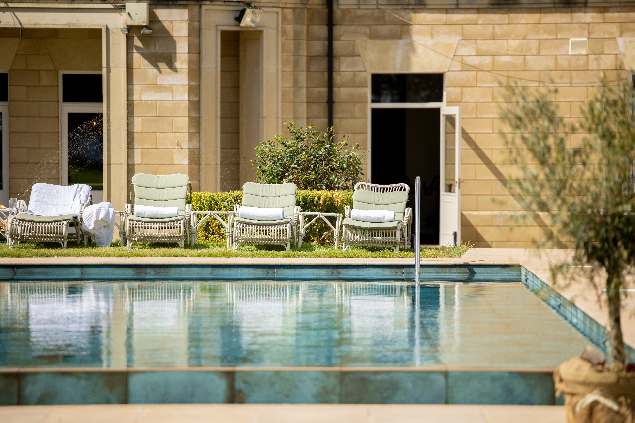 swimming pool with sun loungers