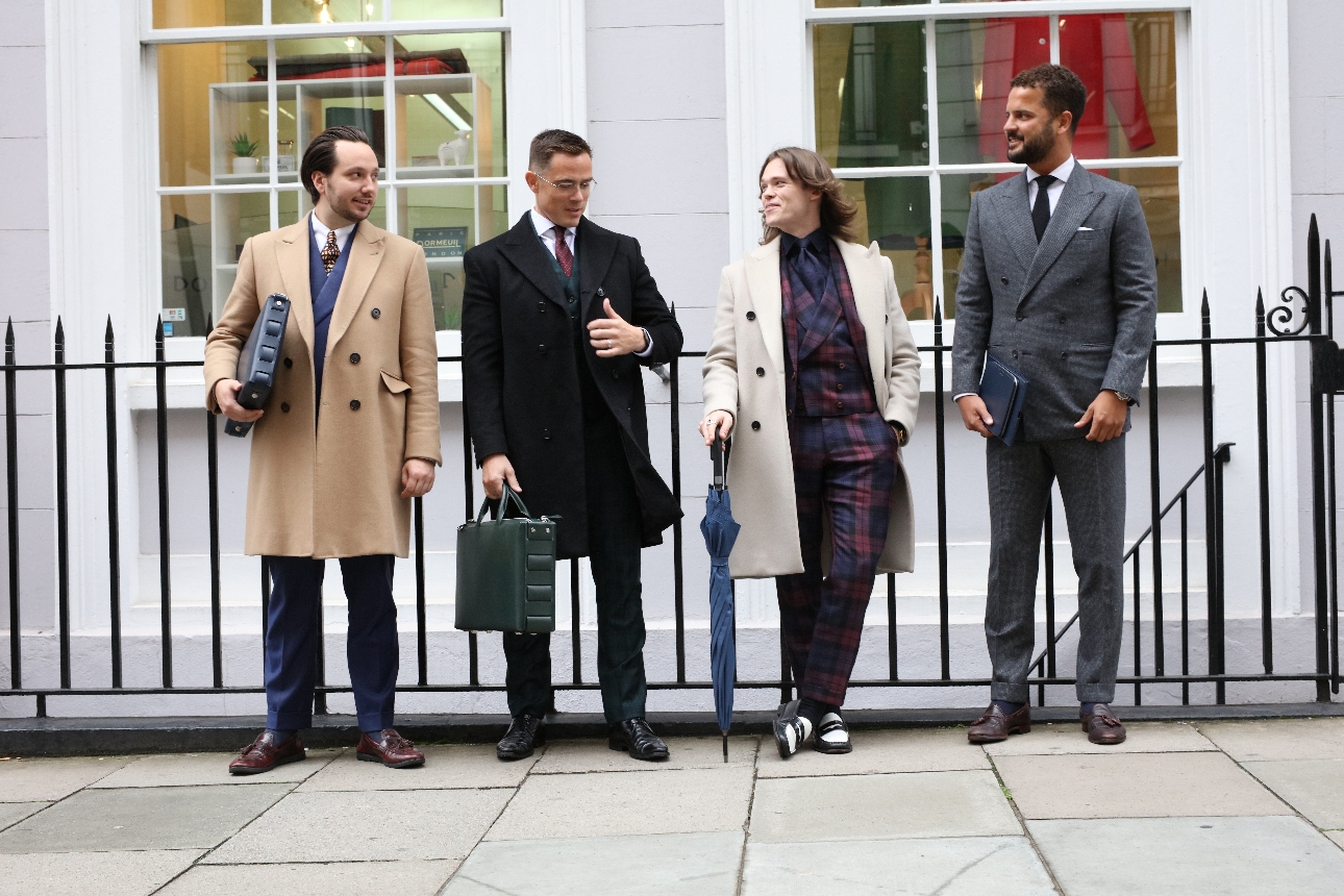 Fielding four men in different suits and smart coats on london street